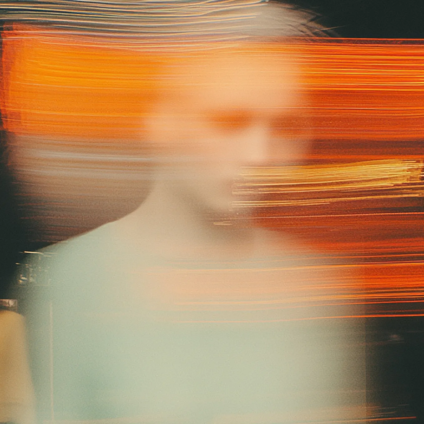 Blurred figure crossed by streaks of amber light