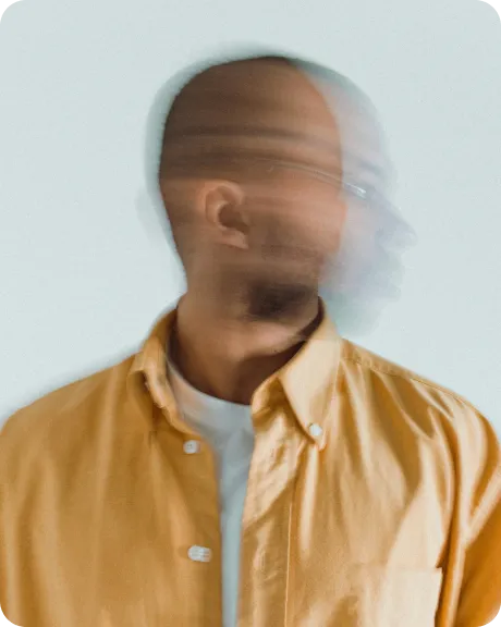 Blurred portrait of a man in a yellow shirt, his face in motion